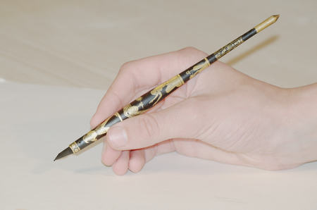 Hand writing with an old stylusの写真素材