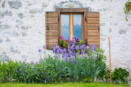 wooden window on stone wallの写真素材