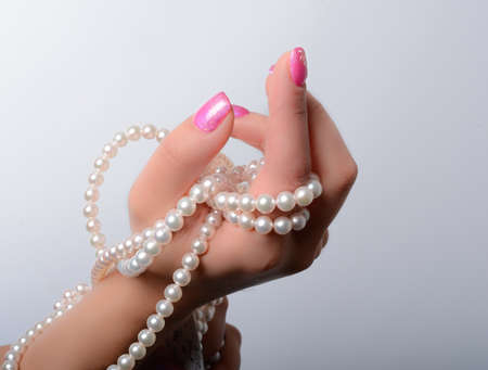 cultured pearls presented with nails painted pinkの写真素材