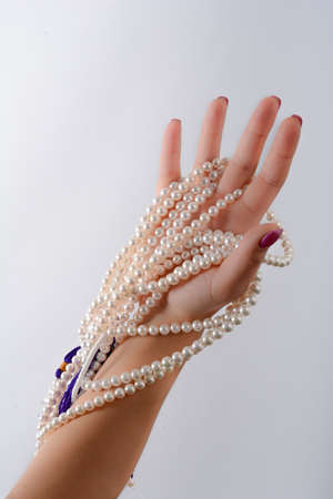 cultured pearls presented with nails painted pinkの写真素材