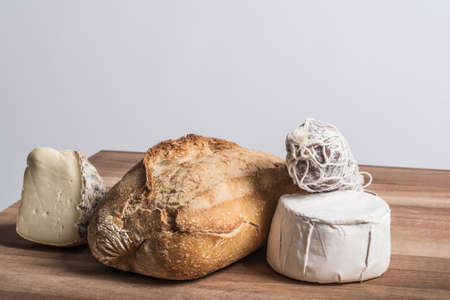 bread, salami and fresh and aged cheesesの写真素材