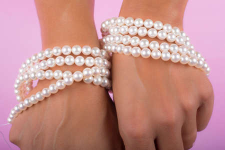 hands with painted nails and pearlsの写真素材