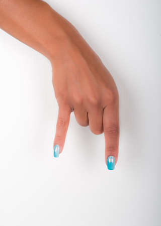 hands with painted nails that hold white sheetの写真素材