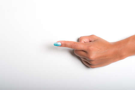 hands with painted nails that hold white sheetの写真素材