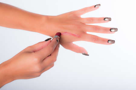 nails decorated with neutral colors and lipstickの写真素材