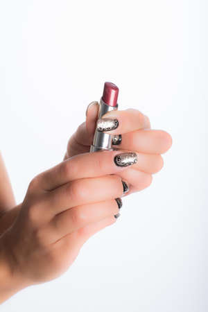nails decorated with neutral colors and lipstickの写真素材
