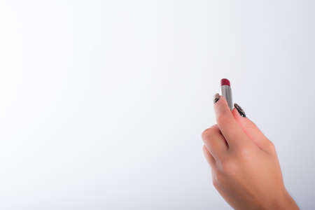 nails decorated with neutral colors and lipstickの写真素材