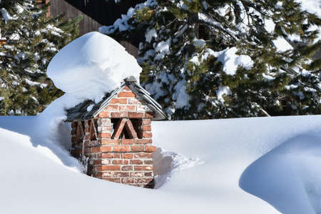 chimney of a mountain hut buried with fresh snowの写真素材