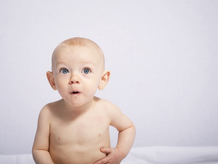 little baby makes a puzzled expression, her first photo session