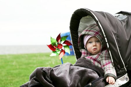 Sad baby girl in a strollerの写真素材