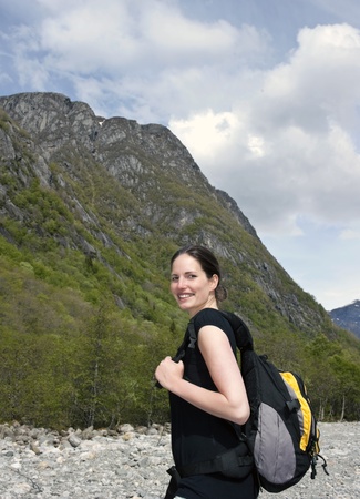 Woman hiker smiling in front of a mountain の写真素材