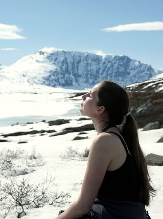 woman take a sunbath in winter landscape 