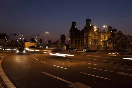 Nightscene in Barcelona, with vehicles on street with motion lights and old building behindの写真素材
