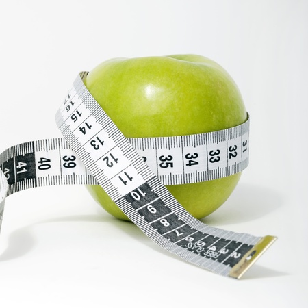 Fresh green apple with measuring tape