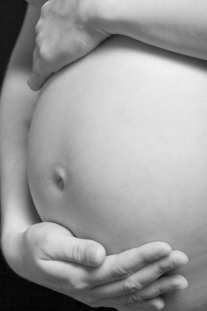 Closeup of a pregnant woman in black and whiteの写真素材