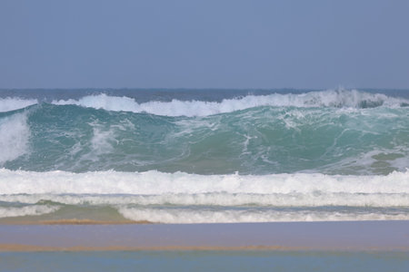 Ocean waves breaking on the sandy beach on the Atlantic coast of Morocco