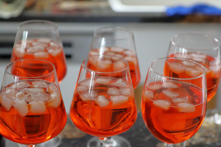 Red cocktail with ice in glasses on a bar counter in a restaurant
