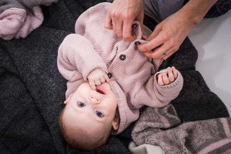 Little baby girl getting dressedの写真素材