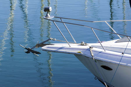 The front of a private watercraft with an anchor and spotlight.