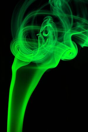 Abstract green smoke over black backgroundの写真素材