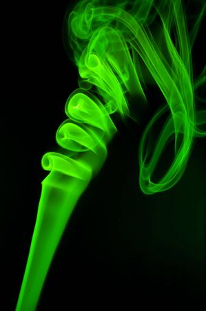 Abstract green smoke over black backgroundの写真素材