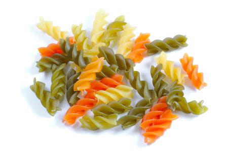 multicolor spiral macaroni. Close up. Isolated over white.の写真素材
