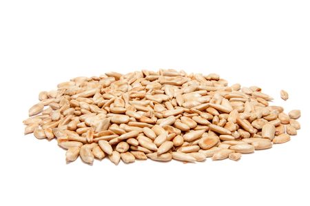 Peeled sunflower seeds. Isolated over whiteの写真素材