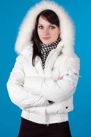 beautiful happy woman in winter clothes. On blue background .の写真素材