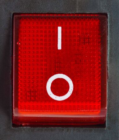 Close up of isolated red power on / off switch .
