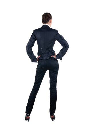 Beautiful young woman looking at wall. Rear view. Isolated over white.の写真素材