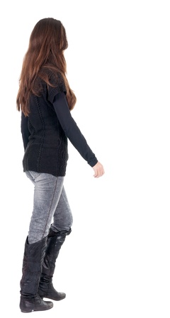 back view of going  woman  in  in jeans and sweater. beauty brunette girl in motion.  backside view of person.  Rear view people collection. Isolated over white background.の写真素材