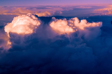 Clouds. bright morning dawn in the sky. sunset with a height of 10 000 km. Top view. night and day. the setting sun sunset light illuminates the upper cloud layersの写真素材