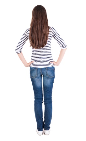 back view of standing young beautiful  brunette woman. Rear view people collection.  backside view of person.  Isolated over white background. beautiful teen girl in a  striped t-shirt with long hair looking into the distanceの写真素材