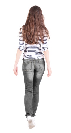 back view of walking  woman in jeans . beautiful brunette girl in motion.  backside view of person.  Rear view people collection. Isolated over white background. The girl in a striped T-shirt with sleeves podkatannymi goes aheadの写真素材