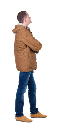 Back view of handsome man in winter jacket  looking up.   Standing young guy in parka. Rear view people collection.  backside view of person.  Isolated over white background.の写真素材
