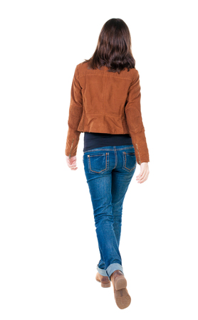 back view of walking  woman in brown jacket. beautiful brunette girl in motion.  backside view of person.  Rear view people collection. Isolated over white background.の写真素材