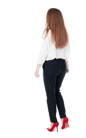 walking red head business woman. back view. going young girl in  suit. Rear view people collection.  back side view of person.  Isolated over white background.の写真素材