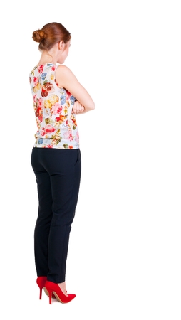 back view of standing young beautiful  redhead woman. girl  watching. Rear view people collection.  backside view of person.  Isolated over white background.の写真素材