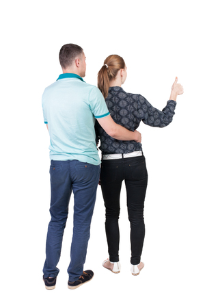 young couple pointing at wal Back view  (woman and man). Rear view people collection.  backside view of person.  Isolated over white background.の写真素材