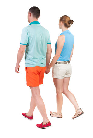  Back view going couple in shorts. walking friendly girl and guy holding hands. Rear view people collection. backside view of person. Isolated over white background. の写真素材