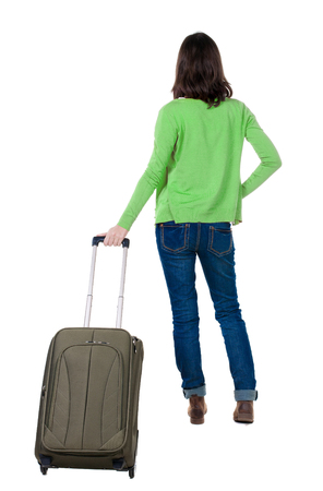 back view of walking  woman  in cardigan with suitcase. beautiful  girl in motion.  backside view of person.  Rear view people collection. Isolated over white background.の写真素材