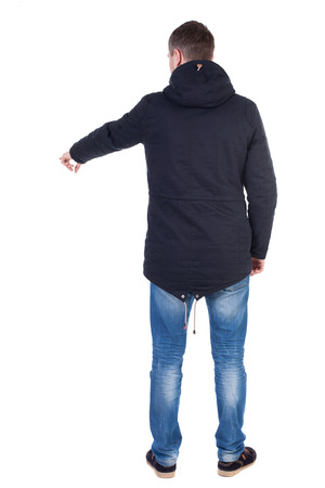 Back view of  pointing young men in parka. Young guy  gesture. Rear view people collection.  backside view of person.  Isolated over white background.の写真素材