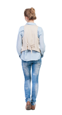 back view of standing young beautiful  blonde woman in brown vest. girl  watching. Rear view people collection.  backside view of person.  Isolated over white background.の写真素材