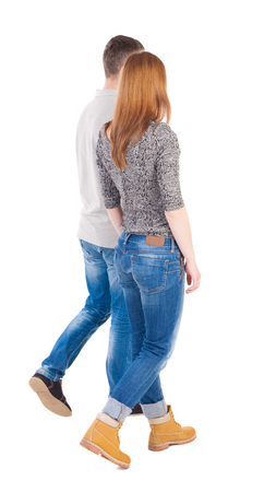 Back view going couple. walking friendly girl and guy holding hands. Rear view people collection. backside view of person. Isolated over white background. The girl in yellow shoes is next to the guy.の写真素材