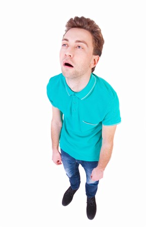 Top view of a bored man. tired man looking up. Isolated over white background. Bored guy. wide-angle lens.の写真素材