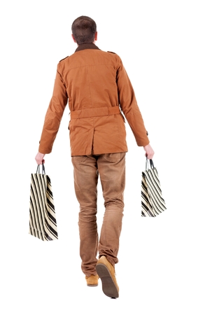 Back view of going  handsome man with shopping bags.  walking young guy is shopping. Rear view people collection.  backside view of person.  Isolated over white background.の写真素材