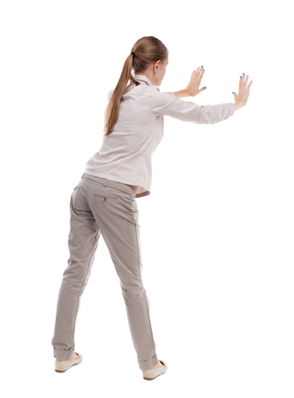 Back View Of Woman Pushes Wall Isolated Over White Background