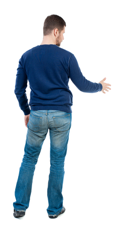 back view of businessman reaches out to shake hands. Rear view people collection. backside view of person. Isolated over white background. bearded man in blue pullover extends his hand in greeting.の写真素材
