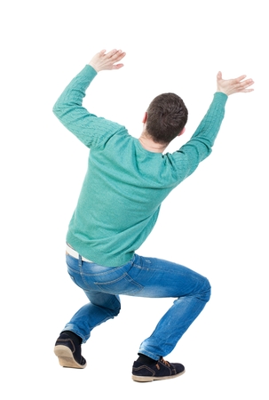 back view. man  protects hands from what is falling from above. Man holding a heavy load Rear view people collection.  backside view of person.  Isolated over white background. The guy is on all fours and keeps the weight on yourself.の写真素材
