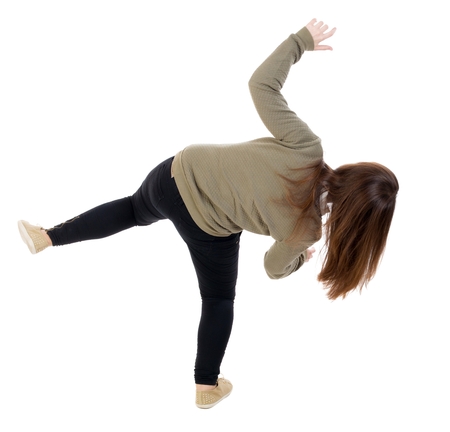 Back view woman Balances waving his arms.   Standing young girl in parka. Rear view people...